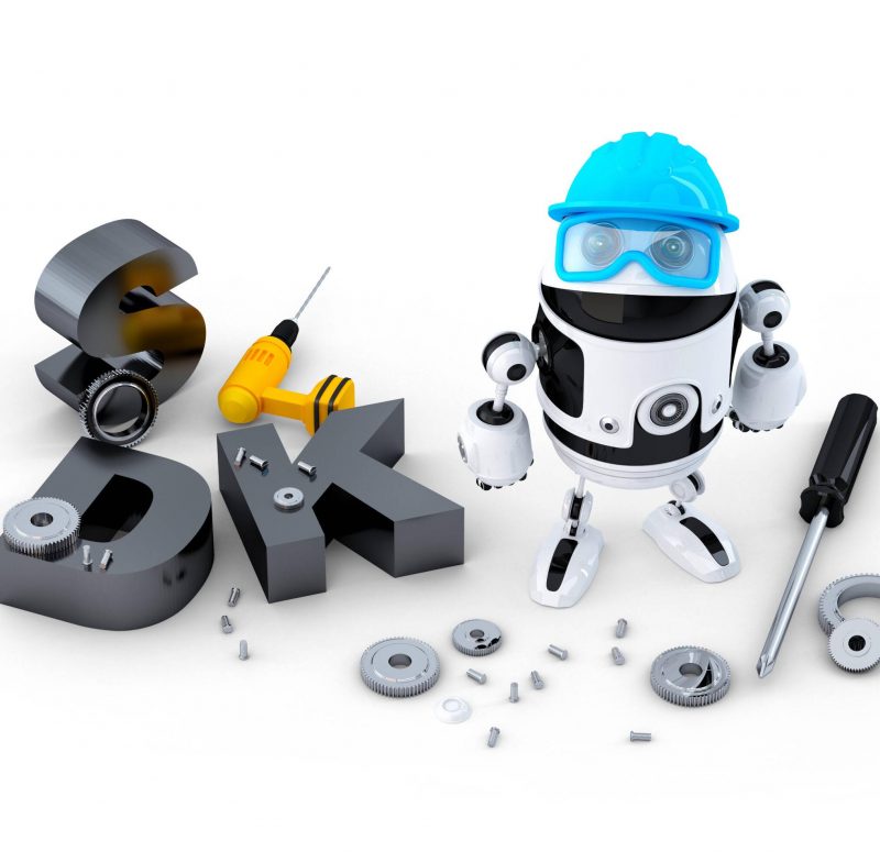 Robot with tools and SDK sign. Technology concept. Isolated over white background HRJRHJ Robot with tools and SDK sign. Technology concept. Isolated over white background