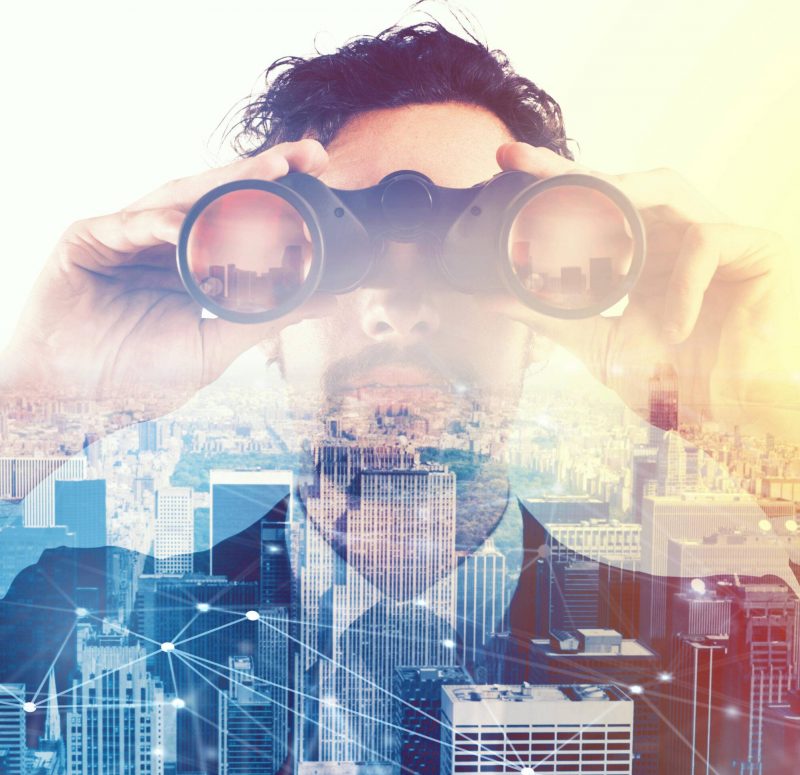 Businessman looking to the future with binoculars K3XA43 Businessman looking to the future with binoculars